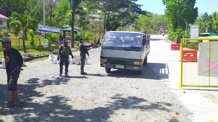 Police personnel conduct quarantine checkpoint at the border of Barangay Fabrica, Hamtic, Antique Police personnel conduct quarantine checkpoint at the border of Barangay Fabrica, Hamtic, Antique. An ambulance driver was arrested there on May 7 for transporting nine boxes of liquor. PNP HAMTIC ANTIQUE