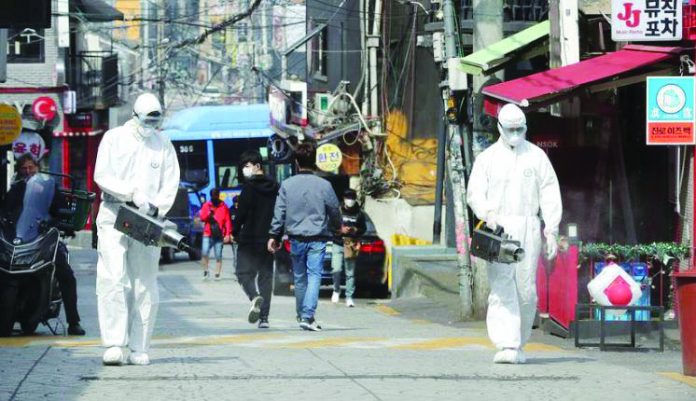 Quarantine workers spray disinfectants at night spots of Itaewon neighborhood