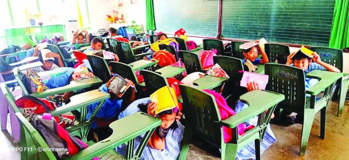 Students of the Sibalom Central Elementary School in Sibalom, Antique participate in an earthquake drill.