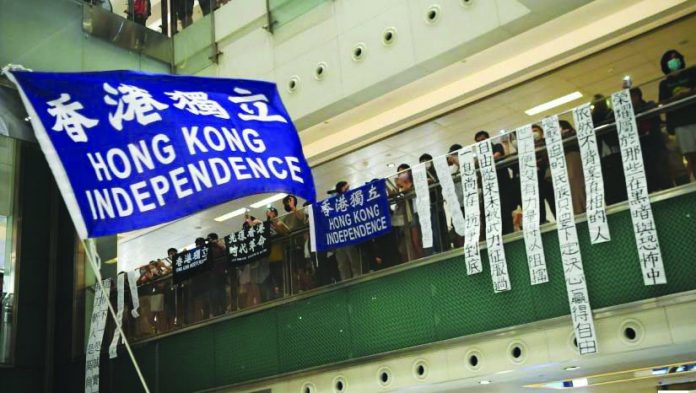 A pro-democracy protester waves a pro-independence banner during a protest at the New Town Plaza mall in Sha Tin in Hong Kong, China June 12, 2020.