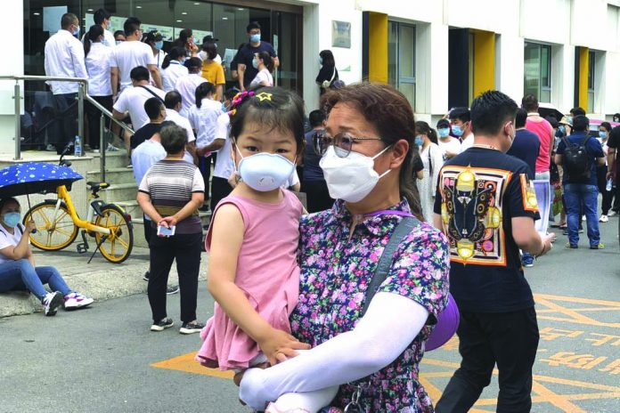 A woman and a child wearing protective face masks to help curb the spread of the new coronavirus