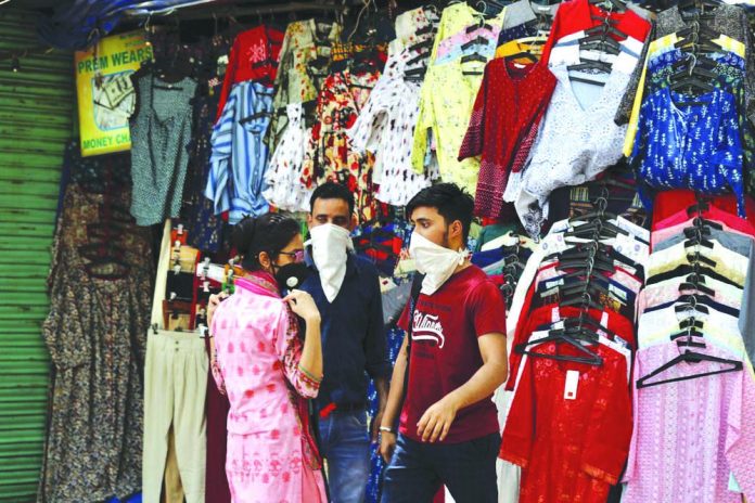 A woman shops for clothes at the Janpath market in New Delhi, India, Monday, June 1, 2020.