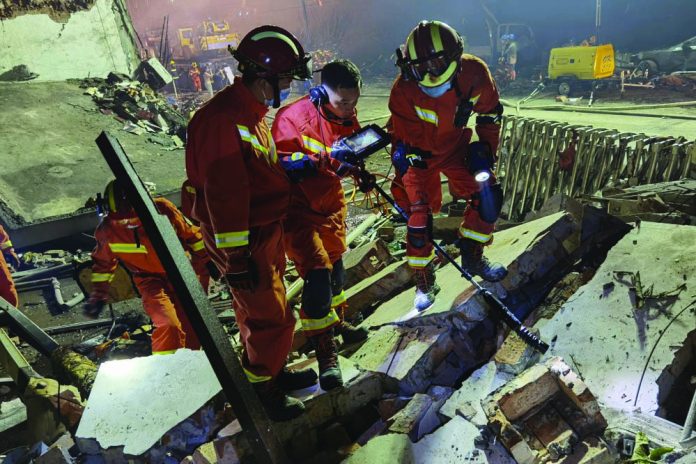 Firefighters look for residents trapped in collapsed buildings in the aftermath of a tanker truck explosion near a highway in Wenling in eastern China's Zhejiang province Saturday, June 13, 2020.