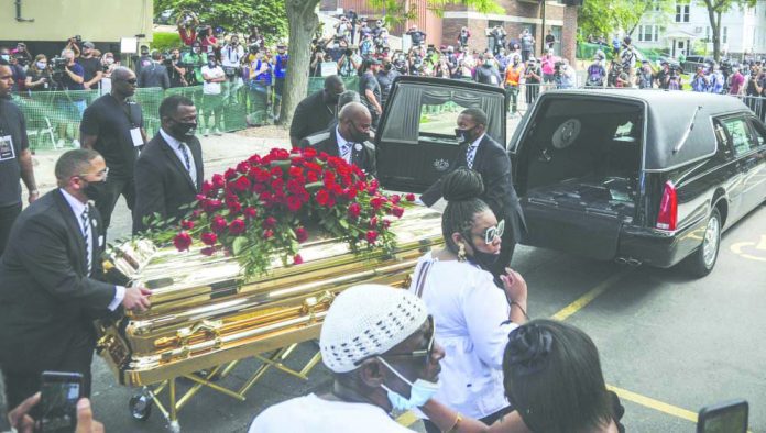 George Floyd's casket carried to a hearse after a memorial service for Floyd at North Central University, Thursday, June 4, 2020, in Minneapolis.