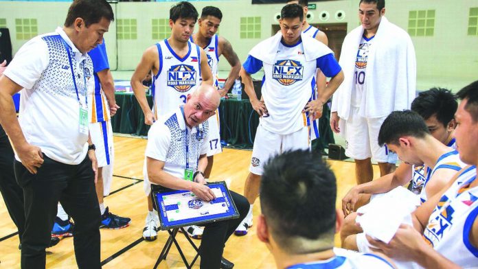 NLEX Road Warriors head coach Joseller “Yeng” discusses a play with his players during a practice session.