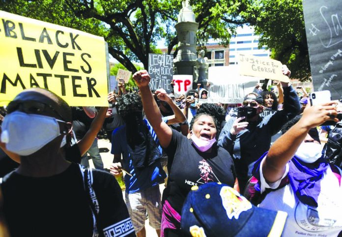 People hold for a Black Lives Matter rally at the Caddo Parish Courthouse in Shreveport, La., Sunday, May 31, 2020.