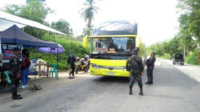Police personnel implement border checkpoint in Altavas, Aklan on June 1.