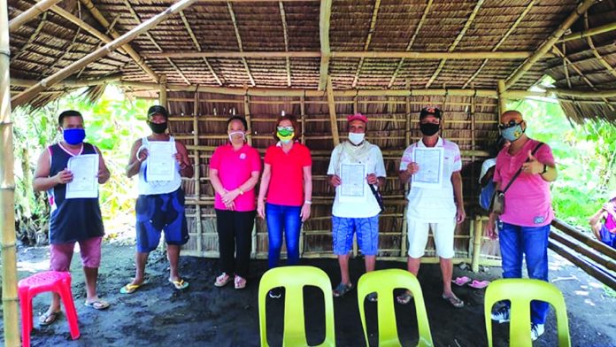Some of the 57 agrarian reform beneficiaries pose with Department of Agrarian Reform Negros Occidental I-North personnel during the installation ceremony in Barangay Nanca, E.B Magalona town on June