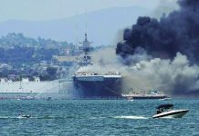 US Navy warship catches fire; at least 21 injured A recreational boat pulls a person on an inner tube on San Diego Bay in California, USA as firefighting boats spray water onto the US Navy amphibious assault ship USS Bonhomme Richard on July 12, 2020. Fire broke out onboard the ship. At least 21 sailors were hurt. REUTERS