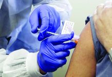 In this March 16, 2020 file photo, a subject receives a shot in the first-stage safety study clinical trial of a potential vaccine by Moderna for COVID-19, at the Kaiser Permanente Washington Health Research Institute in Seattle. AP