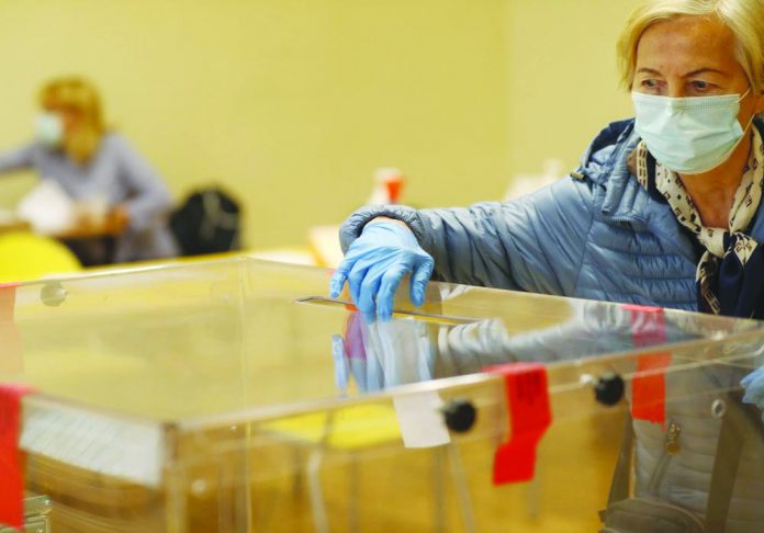 A woman casts her vote during presidential runoff election in Krakow, Poland, Sunday, July 12, 2020. A woman casts her vote during presidential runoff election in Krakow, Poland, Sunday, July 12, 2020. AP PHOTO/PETR DAVID JOSE