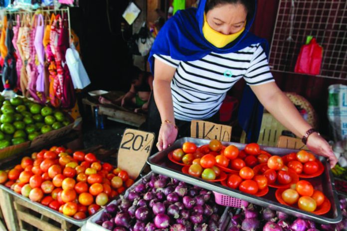 A woman sells locally sourced tomatoes as she tends to her vegetable stall in Trabaho market in Manila on June 9, 2020. A woman sells locally sourced tomatoes as she tends to her vegetable stall in Trabaho market in Manila on June 9, 2020. ABS-CBN