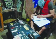 An operative of the Bacolod City Police Office Station 2 inspects suspected shabu seized from four arrested suspects during a buy-bust operation in Barangay Tangub. The suspects yielded 19 sachets of suspected illegal drugs valued at around P224,000. POLICE STATION 2/BCPO
