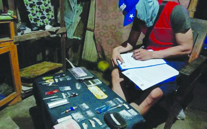 An operative of the Bacolod City Police Office Station 2 inspects suspected shabu seized from four arrested suspects during a buy-bust operation in Barangay Tangub. An operative of the Bacolod City Police Office Station 2 inspects suspected shabu seized from four arrested suspects during a buy-bust operation in Barangay Tangub. The suspects yielded 19 sachets of suspected illegal drugs valued at around P224,000. POLICE STATION 2/BCPO