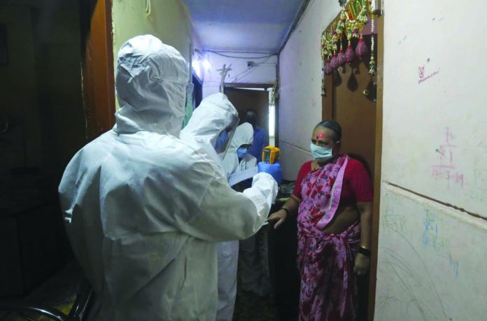 Health workers screen people for COVID-19 symptoms at a residential building in Dharavi, one of Asia's biggest slums, in Mumbai, India on July 17, 2020. Health workers screen people for COVID-19 symptoms at a residential building in Dharavi, one of Asia's biggest slums, in Mumbai, India on July 17, 2020. AP PHOTO/RAFIQ MAQBOOL