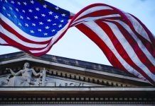 US accuses Chinese hackers of targeting COVID-19 research In this March 22, 2019 file photo, an American flag flies outside the Department of Justice in Washington. The Justice Department has accused two Chinese hackers of stealing hundreds of millions of dollars of trade secrets from companies across the world and more recently targeting firms developing a vaccine for the coronavirus. AP