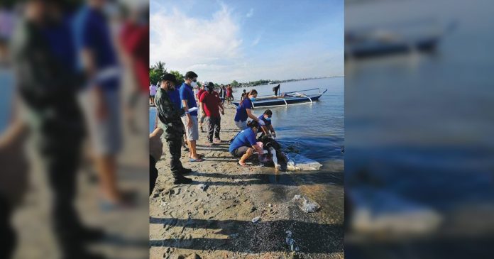 Personnel of Bacolod and Talisay Disaster Risk Reduction Management offices bring the body of Carl Gabriel Cabrillo ashore in Talisay City, Negros Occidental on July 17. Personnel of Bacolod and Talisay Disaster Risk Reduction Management offices bring the body of Carl Gabriel Cabrillo ashore in Talisay City, Negros Occidental on July 17. TALISAY CITY POLICE STATION