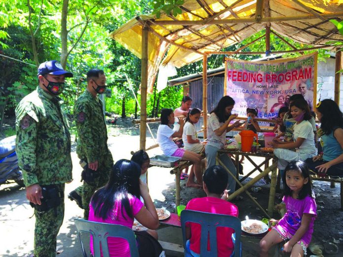 Police personnel conduct feeding program to residents of Barangay San Jose, Binalbagan, Negros Occidental on July 15. Negros Occidental Police Provincial Office officer-in-charge Colonel Romy Palgue commended his men for their recognition as the top-performing unit in Western Visayas for June. BINALBAGAN PNP