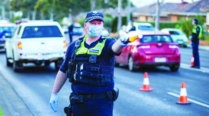 Police stop drivers at a checkpoint as coronavirus disease cases spike in Melbourne Police stop drivers at a checkpoint, set up in response to the state of Victoria’s surge in coronavirus disease cases and resulting suburb lockdowns, in Melbourne, Australia. REUTERS