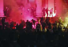 Serbia police detain 71 people after 4th night of virus protests Protesters clash with riot police on the steps of the Serbian parliament during a protest in Belgrade, Serbia, Friday, July 10 2020. AP