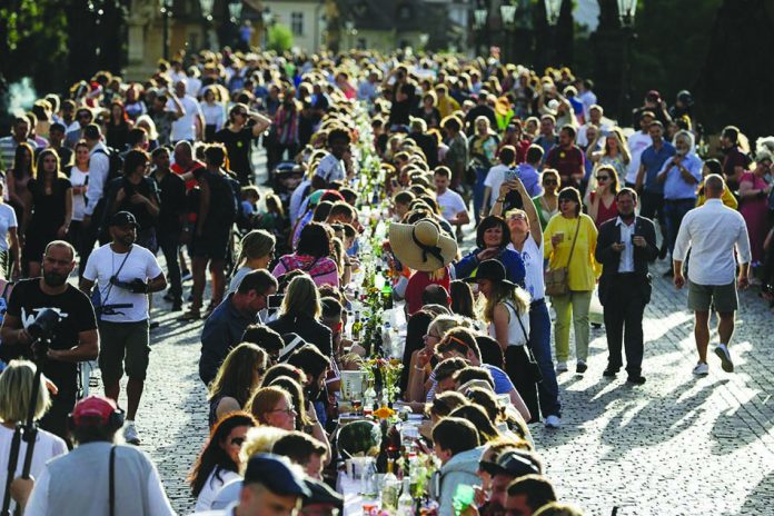 Residents dine at a 500-meter-long table spanning across the length of the medieval Charles Bridge as restrictions ease following the coronavirus disease outbreak, in Prague, Czech Republic, June 30