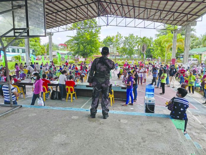 SAP Antique This police officer provides security during the distribution of special amelioration program (SAP) cash assistance in Barangay Malandog, Hamtic, Antique on July 3. The provision of emergency subsidy to the SAP additional beneficiaries is mandated under Memorandum Circular Number 14, series 2020 issued by DSWD Secretary Rolando Joselito Bautista last June 1. HAMTIC PNP PCR