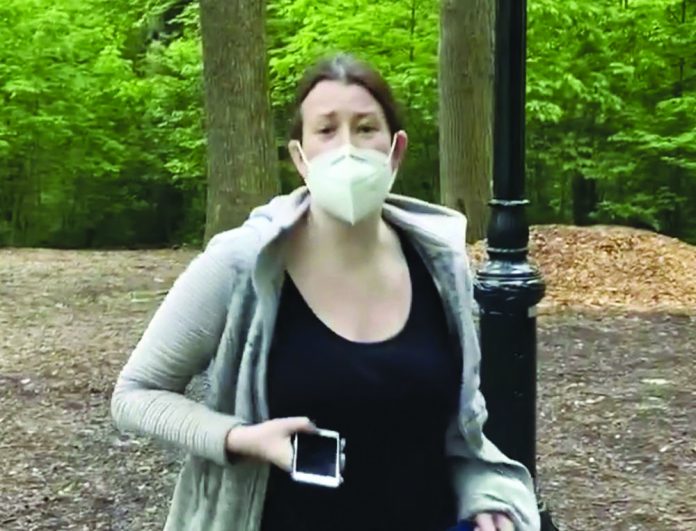 This file image made from May 25, 2020 video provided by Christian Cooper, shows Amy Cooper with her dog talking to Christian Cooper in Central Park in New York.