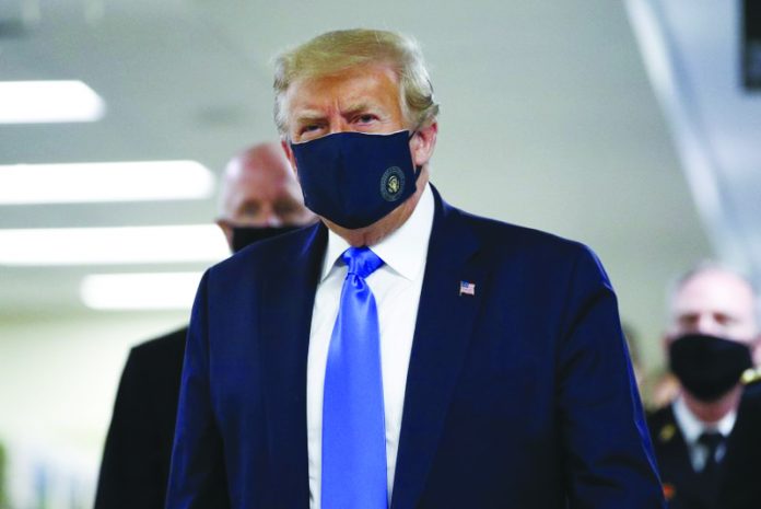 Trump United States President Donald Trump wears a mask as he walks down the hallway during his visit to Walter Reed National Military Medical Center in Bethesda, Md., Saturday, July 11, 2020. AP PHOTO/PATRICK SEMANSKY