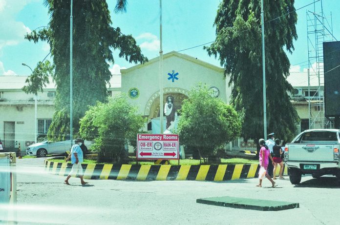 WVMC People walk past the front of Western Visayas Medical Center’s emergency room in Mandurriao, Iloilo City.