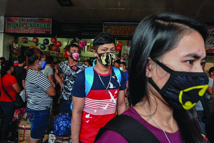 COVID 19 Bus Train Commuters The World Health Organization says that only non-medical fabric masks can be reused but these should be washed with water and detergent. RAPPLER