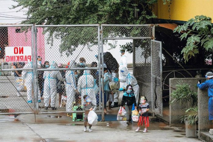 front pic SO GOOD TO BE BACK…BUT IT’S NOT QUITE HOME YET FOR LSIS. Ilonggos stranded in Metro Manila for months due to quarantine travel restrictions have finally returned to Iloilo. They are shown here passing through a gate of Fort San Pedro regulated by several frontliners wearing personal protective equipment. From Fort San Pedro yesterday, they were fetched by ambulances sent by their respective local government units and taken to their localities’ quarantine facilities for swabbing. IAN PAUL CORDERO/PN