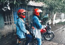 A husband and his wife in Lapuz, Iloilo City get ready to travel using their motorcycle with a plastic barrier separating them. The barrier aims to ensure physic al distancing between the driver and back-rider to prevent the transmission of SARS-CoV-2, the virus that causes the coronavirus disease 2019. IAN PAUL CORDERO/PN
