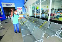 This worker disinfects the waiting area of the New Iloilo Ferry Terminal in Lapuz, Iloilo City on Wednesday. The fastest way to reach Iloilo from Bacolod City or vice versa is through fast crafts. Renewed travel restrictions between the two cities were lifted yesterday. IAN PAUL CORDERO/PN