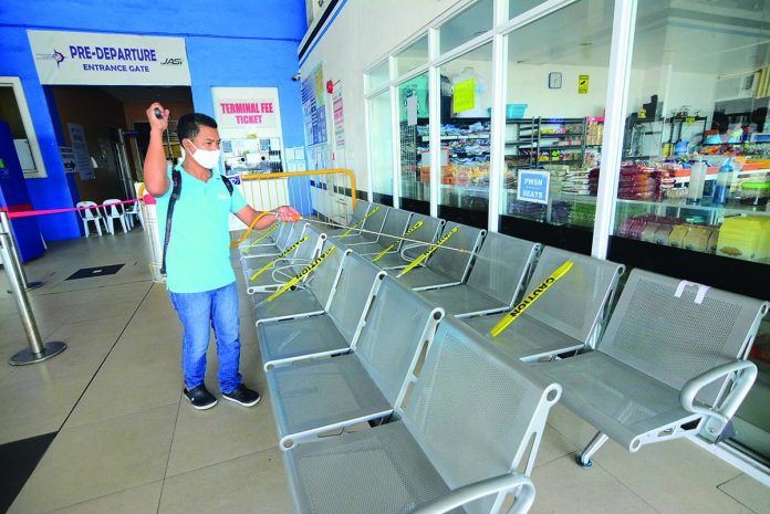 worker disinfects This worker disinfects the waiting area of the New Iloilo Ferry Terminal in Lapuz, Iloilo City on Wednesday. The fastest way to reach Iloilo from Bacolod City or vice versa is through fast crafts. Renewed travel restrictions between the two cities were lifted yesterday. IAN PAUL CORDERO/PN