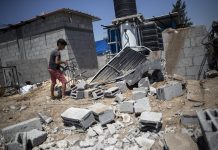 Israel shuts Gaza fishing zone after overnight fighting A Palestinian boy inspects the damage in his family home following Israeli airstrikes in Buriej refugee camp, central Gaza Strip, Saturday, Aug. 15, 2020. AP PHOTO/KHALIL HAMRA