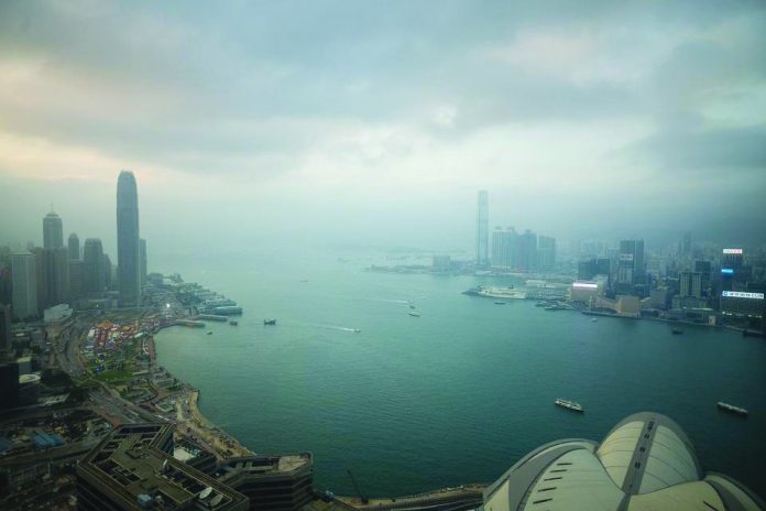 A general view shows ships sailing through Victoria Harbour and commercial buildings in the Kowloon district (right) and Hong Kong island (left) in this file photo taken December 19, 2018. AFP