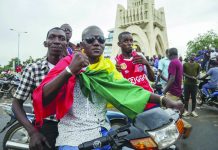 Mali’s president resigns after armed mutiny A man wears a national flag as he celebrates with others in the streets in Mali’s capital Bamako on August 18, 2020. Mutinous soldiers detained Mali’s president and prime minister Tuesday after surrounding a residence and firing into the air in an apparent coup attempt after several months of demonstrations calling for President Ibrahim Boubacar Keita’s ouster. AP