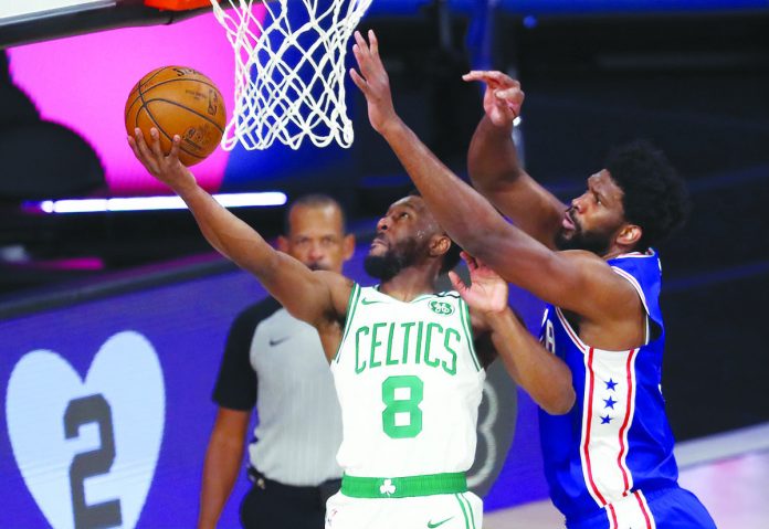Celtics 76ers Basketball Boston Celtics’ Kemba Walker blows past the defense of Philadelphia 76ers’ Joel Embiid for a reverse basket. AP