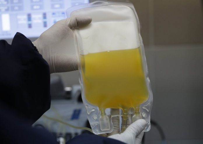 In this Friday, June 12, 2020 file photo, a doctor holds a bag of blood plasma donated by a COVID-19 survivor at blood bank in La Paz, Bolivia. AP