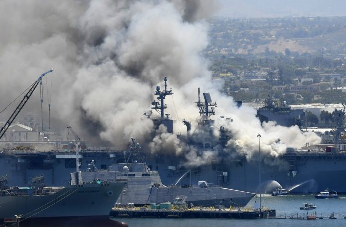 In this July 12, 2020, file photo, smoke rises from the USS Bonhomme Richard at Naval Base San Diego in San Diego, after an explosion and fire on board the ship at Naval Base San In this July 12, 2020, file photo, smoke rises from the USS Bonhomme Richard at Naval Base San Diego in San Diego, after an explosion and fire on board the ship at Naval Base San Diego. AP