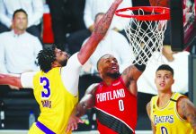 Lakers mauls Blazers, levels NBA series at 1-1 Los Angeles Lakers forward Anthony Davis (3) blocks a shot by Portland Trail Blazers guard Damian Lillard (0) as Lakers forward Kyle Kuzma (0) looks on during the first half of Game 2 of an NBA basketball first-round playoff series, Thursday, in Lake Buena Vista, Florida. AP