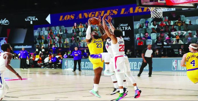 Los Angeles Lakers’ Lebron James goes up against two Los Angeles Clippers defenders. Los Angeles Lakers’ Lebron James goes up against two Los Angeles Clippers defenders. GETTY IMAGES