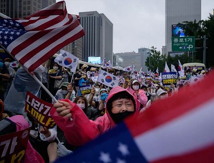 Members of conservative and religious Christian groups during an antigovernment rally in Seoul, South Korea on Saturday. Members of conservative and religious Christian groups during an antigovernment rally in Seoul, South Korea on Saturday. AFP/GETTY IMAGES