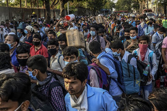 INDIA REOPENING 6 Migrant workers crowd outside a train station in Mumbai, India to board trains to their home state, Bihar, on May 20, 2020. Migrant workers are becoming infected with the coronavirus at an alarmingly high rate, leading to fresh outbreaks in villages across northern India. THE NEW YORK TIMES