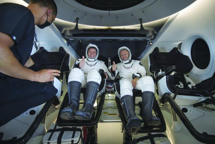 NASA astronauts Robert Behnken (left) and Douglas Hurley are seen inside the SpaceX Crew Dragon Endeavour spacecraft onboard the SpaceX GO Navigator recovery ship shortly after having landed NASA astronauts Robert Behnken (left) and Douglas Hurley are seen inside the SpaceX Crew Dragon Endeavour spacecraft onboard the SpaceX GO Navigator recovery ship shortly after having landed in the Gulf of Mexico off the coast of Pensacola, Florida, Sunday, August 2, 2020. AP