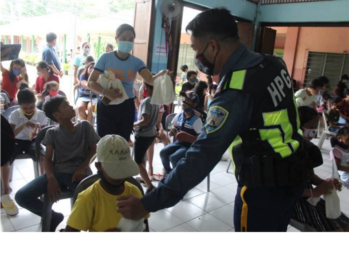 PRO-6 PHOTO. SOS gift giving Police officers distribute gift packs to children at SOS Children’s Village in Zarraga, Iloilo. PRO-6 PHOTO