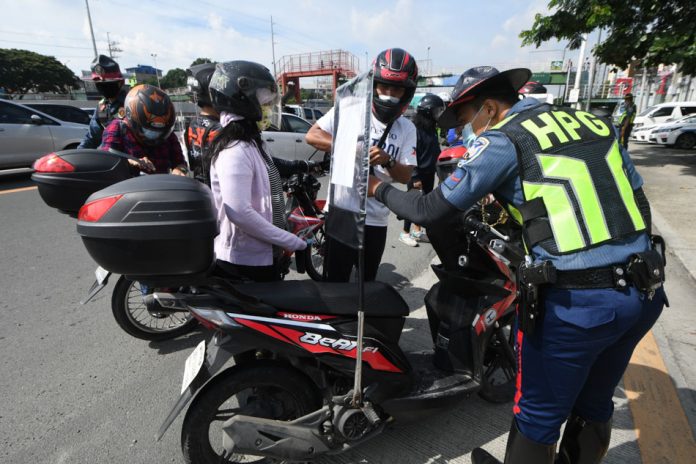 COVID-19 motorcycle backriding Personnel of the Philippine National Police Highway Patrol Group inspect motorcycle drivers with back riders. The Inter-Agency Task Force on the Management of Emerging Infectious Diseases mandates the installation of barriers for motorcycle back-riding couples as a safety measure against coronavirus. ABS-CBN NEWS