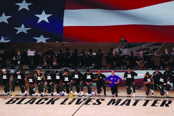Players and coaches of Los Angeles Lakers and Los Angeles Clippers kneel as they sang the national anthem during their regular season match in Orlando, Florida. Players and coaches of Los Angeles Lakers and Los Angeles Clippers kneel as they sang the national anthem during their regular season match in Orlando, Florida. USA TODAY