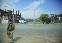 Policemen and paramilitary soldiers patrol a road during curfew in Srinagar, Indian controlled Kashmir, Tuesday, Aug. 4, 2020. AP