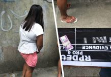 Drug suspect Catherine Villaruz hides her face while antidrug officers inspect items seized from her in an entrapment operation in Barangay Burgos-Mabini, La Paz, Iloilo City on Aug. 16. IAN PAUL CORDERO/PN